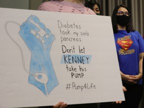 Nikki Deakin (right) takes part in an NDP press conference urging the UCP to halt plans to cancel insulin pump supports, in Edmonton, Monday May 9, 2022.