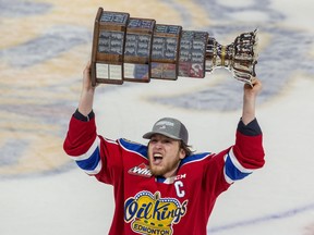 Edmonton Oil Kings captain Jake Neighbors (21) hoists the Ed Chynoweth Cup after defeating the Seattle Thunderbirds 2-0 to win the Western Hockey League Championship series on Monday, June 13, 2022 in Edmonton.