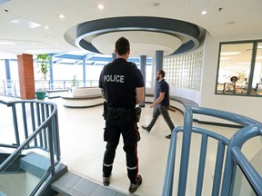 Edmonton Police Service (EPS) school resource officer Const. Lee Martin watches the halls at St. Joseph High School, 10830 109 Street., in Edmonton Thursday May 5, 2022.