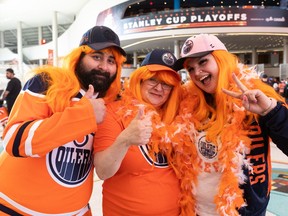 Edmonton Oilers fans Brett Thompson, left, Claudette Shuchuk and Amy Shuchuk show their best team spirit for Game 2 of the Western Conference Stanley Cup Playoffs versus the Colorado Avalanche during a watch party held at Rogers Place in Edmonton on Thursday, June 2, 2022.