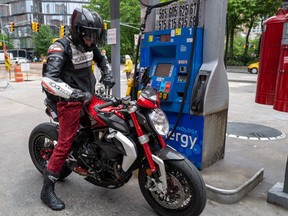 A motorcyclist fills up at a Manhattan gas station on June 01, 2022. New York has suspended its gasoline tax beginning today for the rest of the year in an effort to ease some of the highest gas prices in the nation.