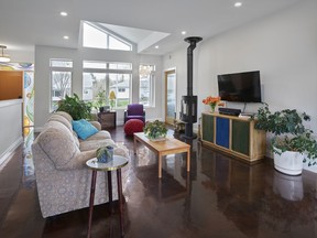 Heat energy entering through south-facing windows is absorbed by concrete floors and slowly released to help satisfy the home's heating needs in the Idylwylde net zero passive solar home featured on the Eco Solar Tour. French doors and no flooring transition from the deck accommodate wheelchair access.