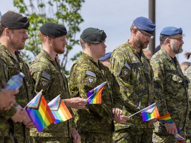 Military members take part in a Pride flag raising ceremony and Pride walk at Canadian Division Support Base (3 CDSB) to celebrate Pride Month on Friday, June 24, 2022 .  This is the first time there has been a Pride parade held at a military base in Canada.