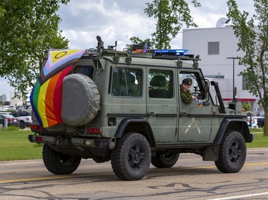 A military police vehicle with a pride flag attached leads the Prides parade after a Pride flag raising ceremony at Canadian Division Support Base (3 CDSB) to celebrate Pride Season at 3rd  on Friday, June 24, 2022 .  This is the first time there has been a Pride parade held at a military base in Canada.
