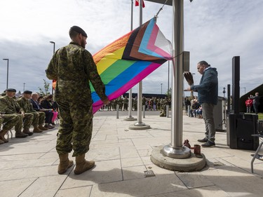 Captain Colin Lussier holds the pride flag while Elder Darin Keewatin blesses it during a Pride flag raising ceremony and Pride walk at Canadian Division Support Base (3 CDSB) to celebrate Pride month on Friday, June 24, 2022 .  This is the first time there has been a Pride parade held at a military base in Canada.