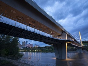 The city skyline can be seen under the Tawatinâ Bridge on Thursday, June 16, 2022, in Edmonton.  A high streamflow advisory is in place for the North Saskatchewan River and water levels are expected to peak on Friday morning.