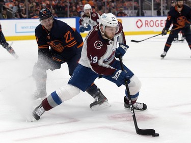 Edmonton Oilers' Tyson Barrie (22) battles the Colorado Avalanche's Nathan MacKinnon (29) during Game 3 of the Western Conference Final at Rogers Place, in Edmonton Saturday June 4, 2022.