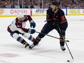 Edmonton Oilers' Connor McDavid (97) battles the Colorado Avalanche's Darren Helm (43) during Game 3 of the Western Conference Final at Rogers Place, in Edmonton Saturday June 4, 2022.