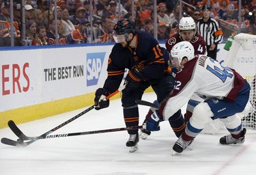 Edmonton Oilers' Zach Hyman (18) battles the Colorado Avalanche's Josh Manson (42) during Game 3 of the Western Conference Final at Rogers Place, in Edmonton Saturday June 4, 2022.