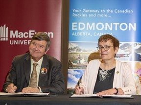 EIA president and CEO Tom Ruth, left, and MacEwan University president Dr. Annette Trimbee sign a memorandum at the university's city centre campus on Thursday, June 2, 2022.