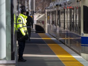 A transit security guard monitors passengers at the Health Sciences/Jubilee LRT station on April 28, 2022 in Edmonton.