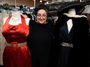 Costume designer Leona Brausen poses with costumes for the upcoming production of Clue opening July 16 at the Citadel Theatre.