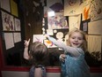 Three-year-old and Gwen Turner, left, and Lisi Hartfeil-Richards, 4,  point out their art pieces on display in the lobby of Metro Cinema, 8712 109 St.