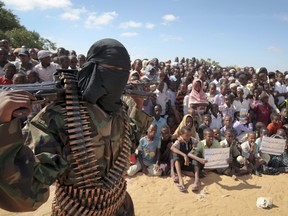 In this Monday, Feb. 13, 2012 file photo, an armed member of the militant group al-Shabab attends a rally in support of the merger of the Somali militant group al-Shabab with al-Qaida, on the outskirts of Mogadishu, Somalia.