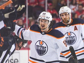 Kailer Yamamoto of the Edmonton Oilers celebrates with the bench after scoring against the Calgary Flames during the third period of Game 1 of the Second Round of the 2022 Stanley Cup Playoffs at Scotiabank Saddledome in Calgary on May 18, 2022.