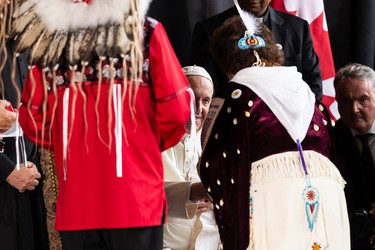 Pope Francis greets members of the official welcoming party as he begin his papal visit in Canada after landing at Edmonton International Airport, on Sunday, July 24, 2022. A brief welcome ceremony greeted the head of the Catholic Church before he headed into Edmonton accompanied by his papal seguito (entourage).