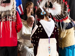 Pope Francis greets members of the official welcoming party as he begin his papal visit in Canada after landing at Edmonton International Airport, on Sunday, July 24, 2022. A brief welcome ceremony greeted the head of the Catholic Church before he headed into Edmonton accompanied by his papal seguito (entourage).