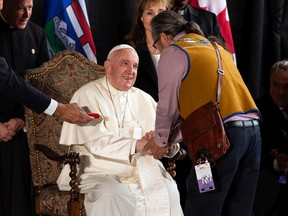 Pope Francis greets Gerald Antoine, regional Chief, Assembly of First Nations, as he starts his his papal visit in Canada after landing at Edmonton International Airport, on Sunday, July 24, 2022. A brief welcome ceremony greeted the head of the Catholic Church before he headed into Edmonton accompanied by his papal seguito (entourage).