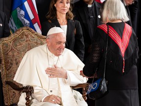 Pope Francis greets Audrey Poitras, President of the Métis Nation of Alberta as he begins his papal visit in Canada after landing at Edmonton International Airport, on Sunday, July 24, 2022. A brief welcome ceremony greeted the head of the Catholic Church before he headed into Edmonton accompanied by his papal seguito (entourage).