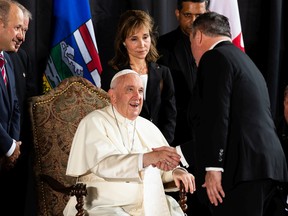 Pope Francis greets Alberta Premier Jason Kenney as starts his papal visit in Canada after landing at Edmonton International Airport, on Sunday, July 24, 2022. A brief welcome ceremony greeted the head of the Catholic Church before he headed into Edmonton accompanied by his papal seguito (entourage).