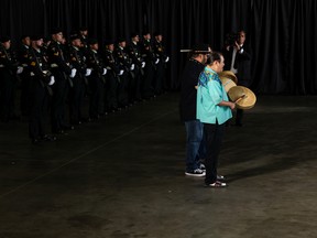 The Logan Alexis Singers from Alexis Nation welcome Pope Francis next to an honour guard from 1 Canadian Mechanized Brigade Group as he starts his papal visit in Canada after landing at Edmonton International Airport, on Sunday, July 24, 2022. A brief welcome ceremony greeted the head of the Catholic Church before he headed into Edmonton accompanied by his papal seguito (entourage).