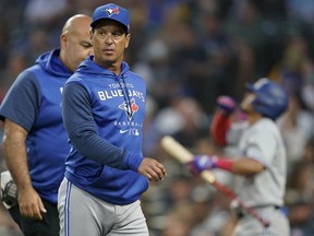 Toronto Blue Jays manager Charlie Montoyo walks with a trainer after Bradley Zimmer was hit by a pitch during the seventh inning of the team's baseball game against the Seattle Mariners on July 7, 2022, in Seattle.