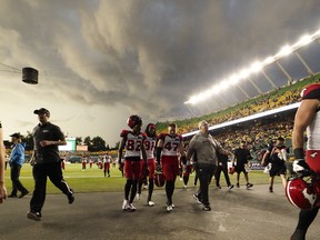 The Edmonton Elks and the Calgary Stampeders leave the field for a lightning delay during second half CFL action at Commonwealth Stadium in Edmonton, on Thursday, July 7, 2022.