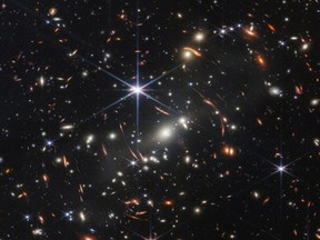 The first full-colour image from NASA's James Webb Space Telescope, a revolutionary apparatus designed to peer through the cosmos to the dawn of the universe, shows the galaxy cluster SMACS 0723, known as Webb's First Deep Field, in a composite made from images at different wavelengths taken with a Near-Infrared Camera and released July 11, 2022.