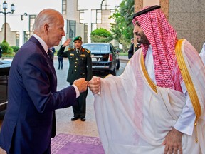 U.S. President Joe Biden bumps fists with Saudi Arabia’s Crown Prince Mohammed Bin Salman at the Saudi Palace on July 15, 2022