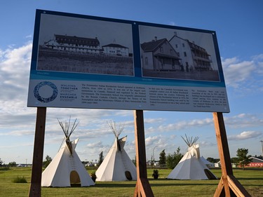 This photograph taken on July 23, 2022, shows historical photographs of the Ermineskin Indian Residential School displayed with tipis in the background in Maskwacis, Alberta, on July 23, 2022, ahead of Pope Francis' visit to Canada. - Pope Francis is expected to offer an apology to Indigenous peoples for more than a century of abuses at state schools run by the church in Canada.