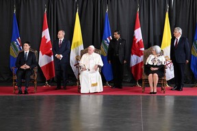 Pope Francis (C), Canadian Prime Minister Justin Trudeau (L) and the Governor General of Canada Mary Simon  take part in a welcoming ceremony for the Pope at Edmonton International Airport in Alberta Providence, Canada, on July 24, 2022. - Pope Francis visits Canada for a chance to personally apologize to Indigenous survivors of abuse committed over a span of decades at residential schools run by the Catholic Church.