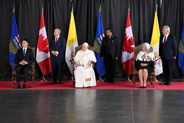 Pope Francis (C), Canadian Prime Minister Justin Trudeau (L) and the Governor General of Canada Mary Simon  take part in a welcoming ceremony for the Pope at Edmonton International Airport in Alberta Providence, Canada, on July 24, 2022. - Pope Francis visits Canada for a chance to personally apologize to Indigenous survivors of abuse committed over a span of decades at residential schools run by the Catholic Church.