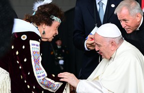 Pope Francis meets a member of an indigenous tribe during his welcoming ceremony at Edmonton International Airport in Alberta, western Canada, on July 24, 2022. - Pope Francis visits Canada for a chance to personally apologize to Indigenous survivors of abuse committed over a span of decades at residential schools run by the Catholic Church.