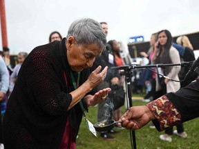 Dennis Lightning offers a smudge ceremony with Buffalo sage to an indigenous community member before the papal visit at Muskwa Park in Maskwacis, Alberta, Canada, on July 25, 2022.