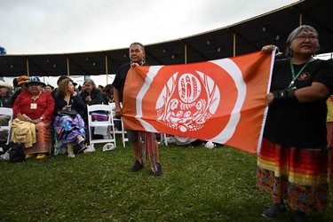 Indigenous community members hold a flag as they await the arrival of Pope Francis at Muskwa Park in Maskwacis, Alberta, Canada, on July 25, 2022.