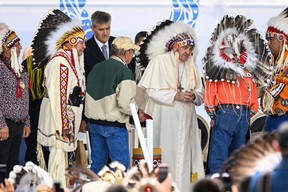 Pope Francis wears a headdress presented to him by Indigenous leaders during a meeting at Muskwa Park in Maskwacis, Alberta, Canada, on July 25, 2022. - Pope Francis will make a historic personal apology Monday to Indigenous survivors of child abuse committed over decades at Catholic-run institutions in Canada, at the start of a week-long visit he has described as a 