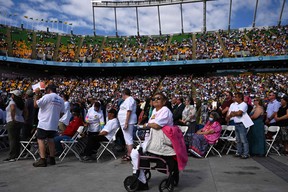 Faithful attend a Mass celebrated by Pope Francis at Commonwealth Stadium in Edmonton, Canada, on July 26, 2022. - The Pope will be celebrating the feast of St. Anne, grandmother of Jesus, a day of particular reverence for Indigenous Catholics.