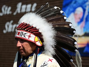 An indigenous community members awaits the arrival of Pope Francis at Lac Ste. Anne, northwest of Edmonton, Alberta, Canada, on July 26, 2022.
