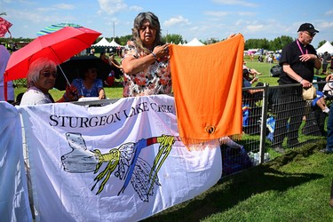 Indigenous community members display a banner reading "Sturgeon Lake Cree Nation" while awaiting the arrival of Pope Francis at Lac Ste. Anne, northwest of Edmonton, Alberta, Canada, on July 26, 2022.
