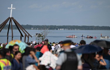 People on boats and on land await the arrival of Pope Francis at Lac Ste. Anne, northwest of Edmonton, Alberta, Canada, July 26, 2022.