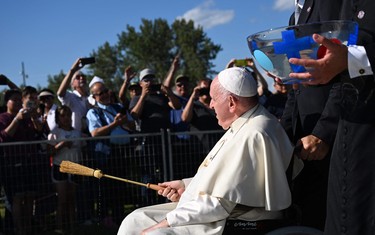 Pope Francis blesses pilgrims with water from the lake during the Lac Ste. Anne Pilgrimage and Liturgy of the Word at Lac Ste. Anne, northwest of Edmonton, Alberta, Canada, July 26, 2022.