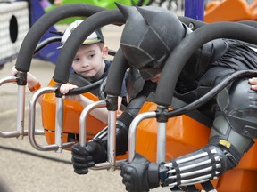 Liam Williams, 5 chats with Batman before the ride begins at K-Days. Monday Morning Magic at K-Days hosted up to 500 special needs children under the age of 13 with many special guest from the Edmonton Elks, firefighters, police officers and super heroes on July 25, 2022. Shaughn Butts - Postmedia