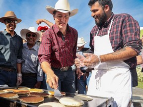 Prime Minister Justin Trudeau flips pancakes at MP George Chahal's Calgary Stampede Breakfast at the Genesis Centre in Calgary on Sunday, July 10, 2022. Gavin Young/Postmedia