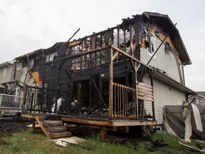 Fire investigators inspect a duplex fire at 130 Street and 162A Avenue on Sunday, July 31, 2022.