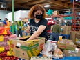 Iuliia Bashtanova prepares food hampers at the Edmonton Food Bank on July 28, 2022.