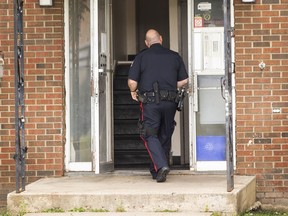 Edmonton police investigate the scene of a homicide on July 31, 2022. An Aug. 4 autopsy has determined that 38-year-old Christopher McMullen, who was found dead at the scene, died of a stab wound.