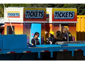 Workers set up ticket booths on Wednesday, July 20, 2022, ahead of the opening of K-Days on Friday on the Edmonton Expo Centre grounds.