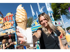 Charli Hoyer shows the mac and cheese soft serve ice cream offered by Summerland Soft Serve during K-Days in Edmonton on Friday, July 22, 2022.