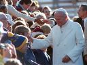 Pope John Paul II greets people attending the papal mass near the Namao Airport on Sept. 17, 1984.