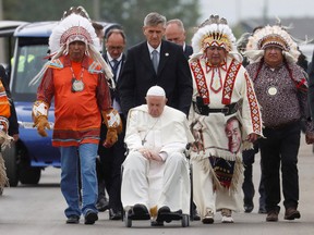 Pope Francis goes down the street with indigenous elders during his visit to Maskwacis, Alberta, Canada July 25, 2022.